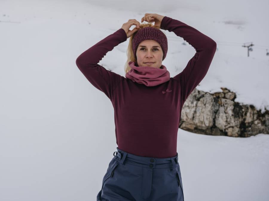 Woman wearing warm base layer in snowy mountain landscape