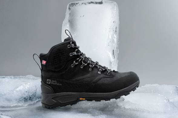 Black winter boat on icy ground