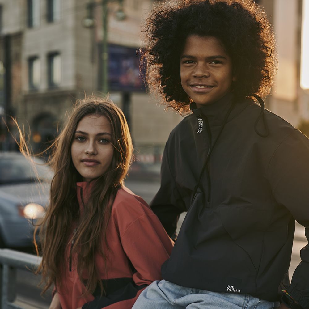 Girl and boy in the street in the sun