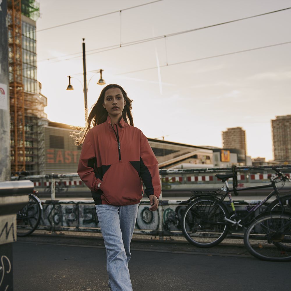 Girl in the street with bicycles in the background