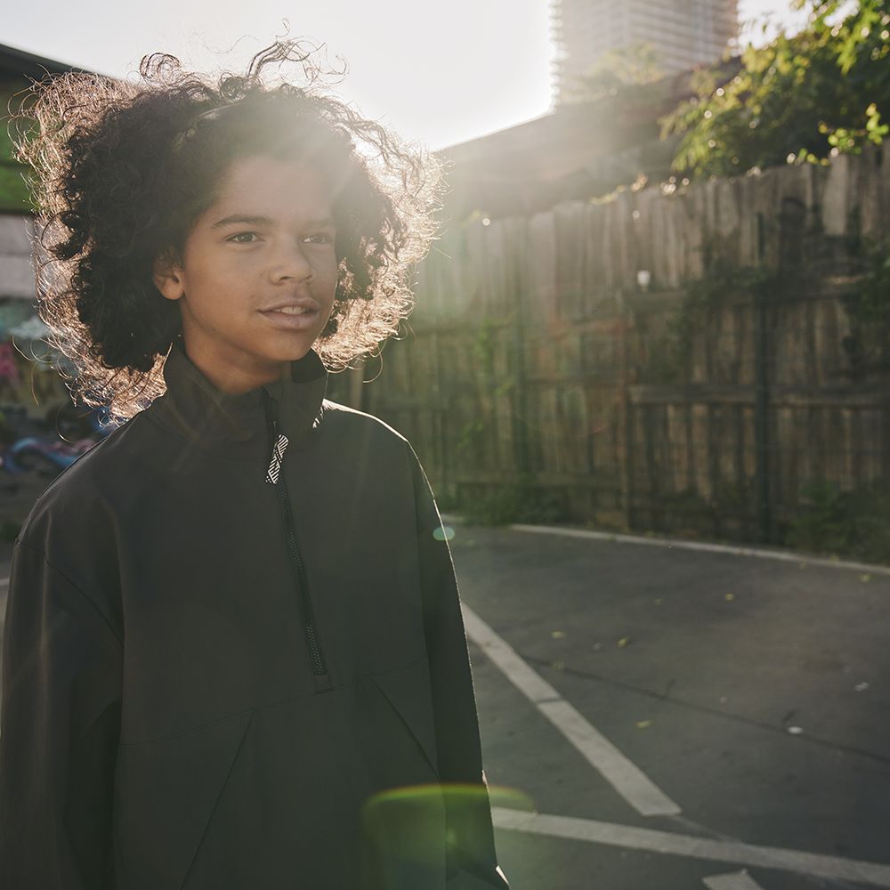 Boy in a car park in the sun
