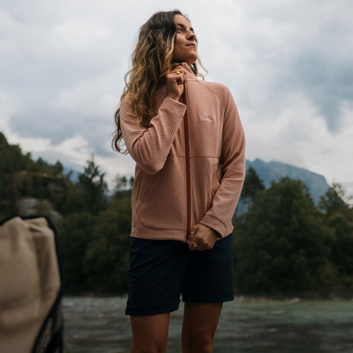 Woman outdoors zipping up her fleece