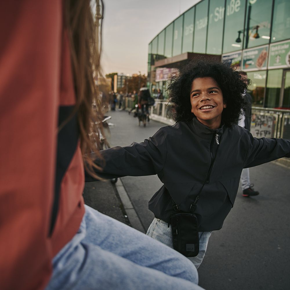 Boy and girl in front of a train station