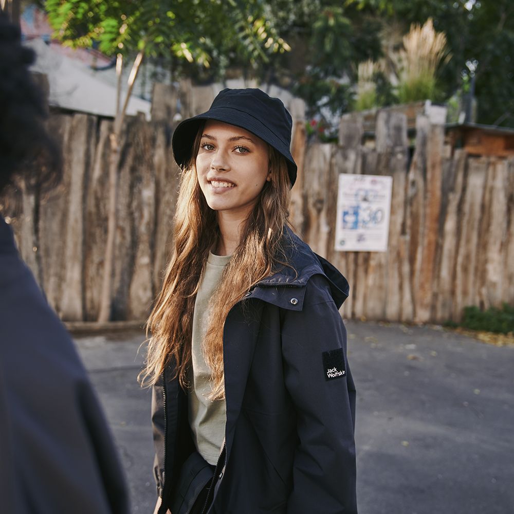 Girl in an outdoor jacket sun hat