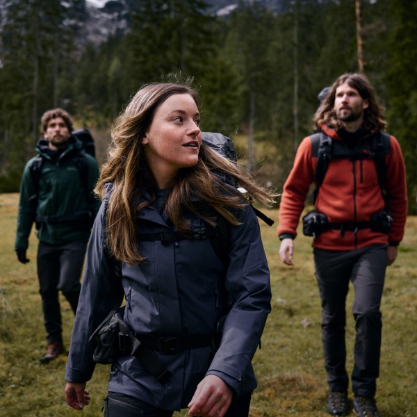 Four hikers walking through a wood